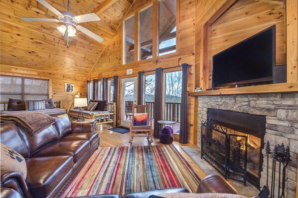 Cozy and spacious living area with TV and fireplace