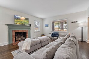 Living room with extremely big, comfy couch and smart television.