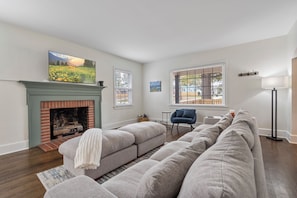 Living room with extremely big, comfy couch and smart television.