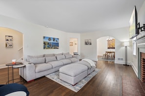 Living room with extremely big, comfy couch and smart television.