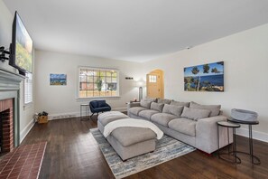 Living room with extremely big, comfy couch and smart television.