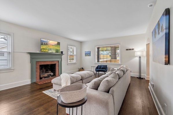 Living room with extremely big, comfy couch and smart television.