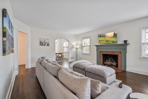 Living room with extremely big, comfy couch and smart television.