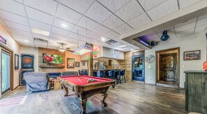 Dance floor with lights next to pool table.