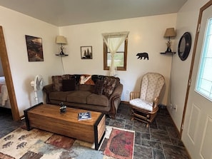Living room with queen sofa sleeper and comfy glider rocker. TV with wifi.