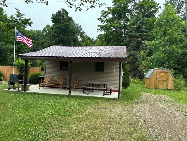 Private covered porch with seating, grill and yard games to enjoy!