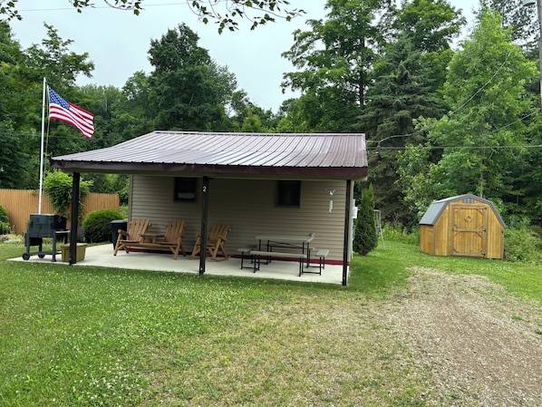 Private covered porch with seating, grill and yard games to enjoy!