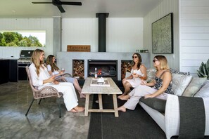 The equipped outdoor kitchen features a large bbq, hot plates, wine fridge, kitchen sink as well as a lounge and open fireplace for those cool winter nights