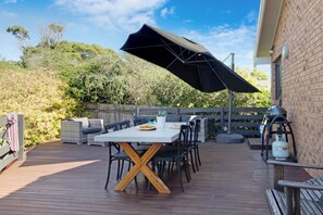 Rear patio area with outdoor furnishings + gas bbq
