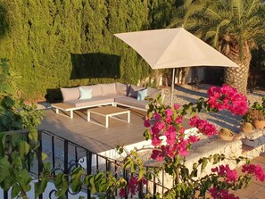 Upper terrace with views of the pool and mountains