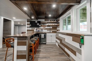 Wet Bar with Sonos speakers and a mini fridge and sink