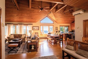 Sunlight floods this inviting living & dining area with sweeping mountain views