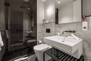 The bathroom highlights a rain shower and is luxuriously appointed to help you feel refreshed.
