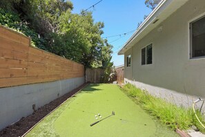 Challenge your friends to a fun round of mini-golf in the backyard.