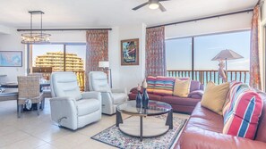 The living room combines comfortable leather sofas, and two leather recliners also.