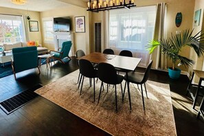 Dining area with seating for 6 at the table and 2 counter stools facing the large kitchen.