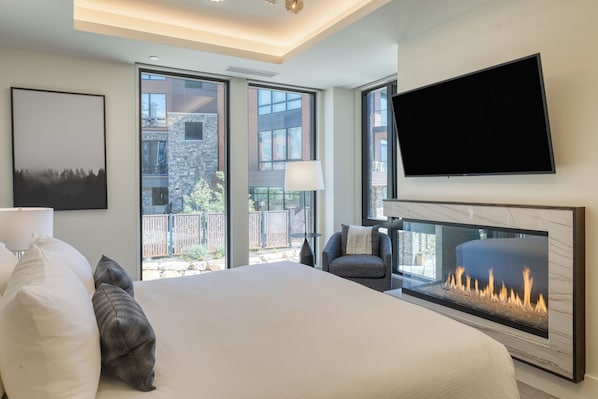 Primary bedroom features a king bed, fireplace, TV, and ensuite bathroom.