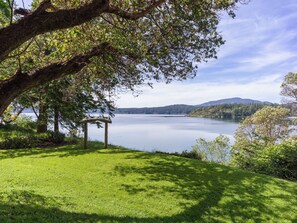 Madrona trees reach out over the sweeping lawns and sea below.