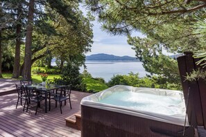 Enjoy the outdoor spa with water views