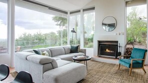 Open Kitchen and Living Room, Tv and Wood Fire. Walk outside to bbq area, upstairs ground level,.