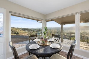 Where Nature Meets Elegance - Enjoy your meals in this chic dining area, with floor-to-ceiling windows showcasing panoramic mountain views!