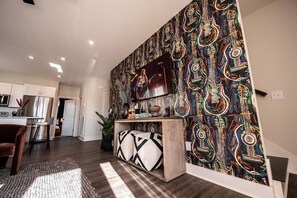 Open concept living area with comfortable seating and TV