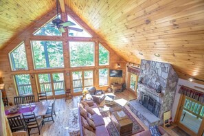 Great Room with 20 ft Ceilings with Enormous Field Stone Fireplace to gather all