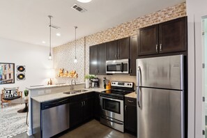 The stylish, open kitchen offers ample space & every home comfort