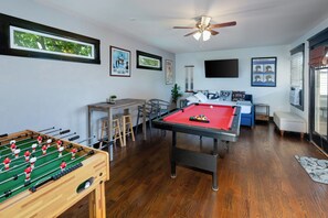 Third Floor Game Room offering Twin Bed & Trundle, Foosball, Pool Table, Smart TV, and Mini Bar Area