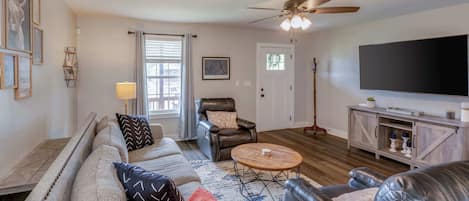 Cozy and spacious living area with TV