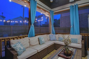 Backyard covered patio seating at night