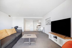 A small table within the living area makes it easy to enjoy meals at home, while the desk space is perfect for those working from home.
