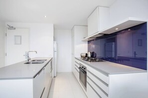 The kitchen is fully equipped for meals at home with an oven, stove, microwave and dishwasher for easy clean-up.
