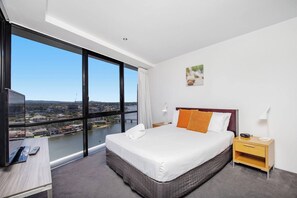 Framing beautiful views across the river, the sumptuous master bedroom comes with a queen bed and built-in wardrobes for storing your belongings.
