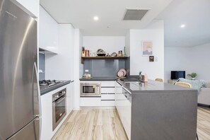 Stone benchtops and stainless-steel appliances makes this kitchen worthy of budding chefs.
