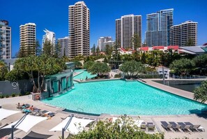 An expansive outdoor pool invites you to soak up the sun, with loungers and umbrellas.