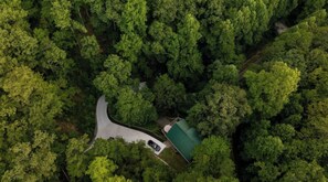 Secluded, nestled on five acres wooded property