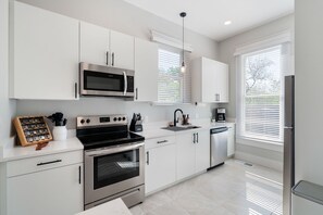 The bright, airy kitchen offers ample space & all the comforts of home