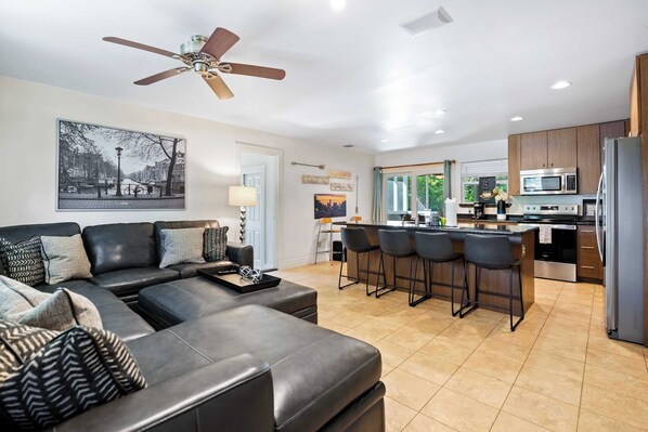 Open living space with sectional sofa, stool seating for 5