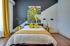 Suite 102 – The 1st Floor Blue Kusama Suite offers King and Queen Casper Beds, Smart TV, Patio Access, and private Bathroom