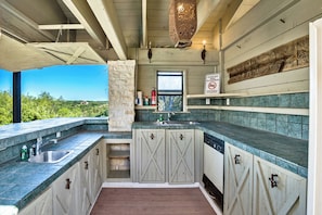 Outdoor kitchenette with sinks, dishwasher, and refrigerator