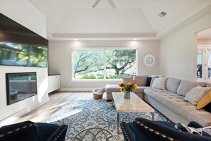 Modern spacious living area with TV