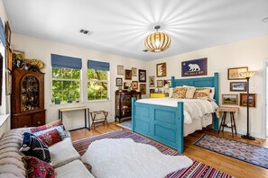 The eclectic 2nd floor queen suite boasts a private en suite & comfy couch