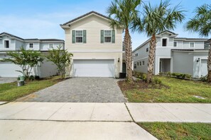 Standalone house with 2 car garage and additional parking in the driveway. 