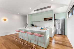 Upstairs features open style living with fully equipped kitchen, butlers pantry