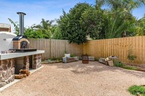 Entertainment area featuring a fire pit and PIZZA OVEN!