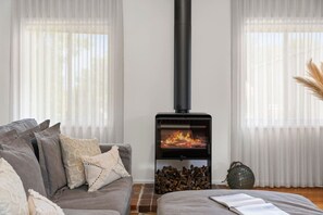 Luxury bedding, comfy couches and a designer wood fireplace
