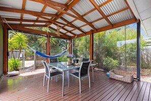 Outdoor dining and weber BBQ complete this space.