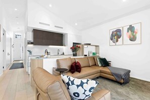 A beautifully styled mid-century & Scandinavia-inspired dining & living zone including a king living leather sofa & chair