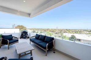 Front deck with outdoor lounges and BBQ